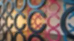 A photograph of a modern art installation featuring a pattern of large letter "C" shapes.